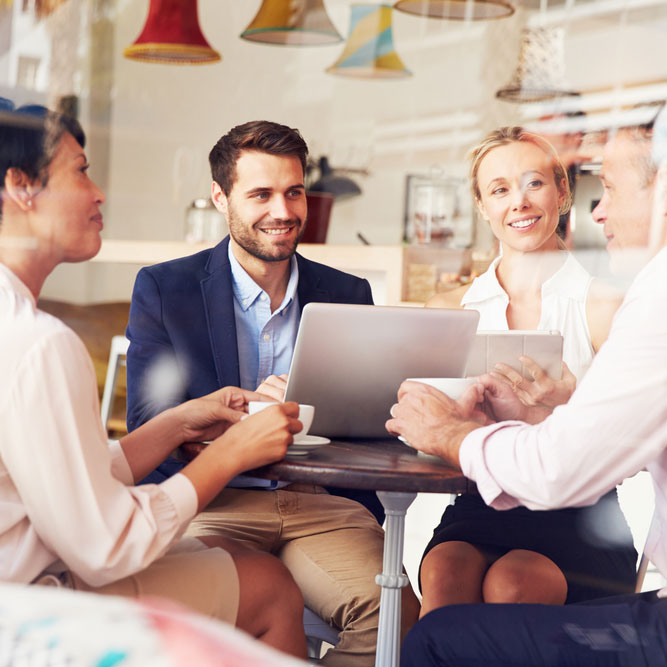 colleagues having a business discussion in a coffee shop