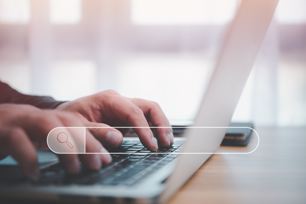 hands of male person typing on laptop and looking for career online