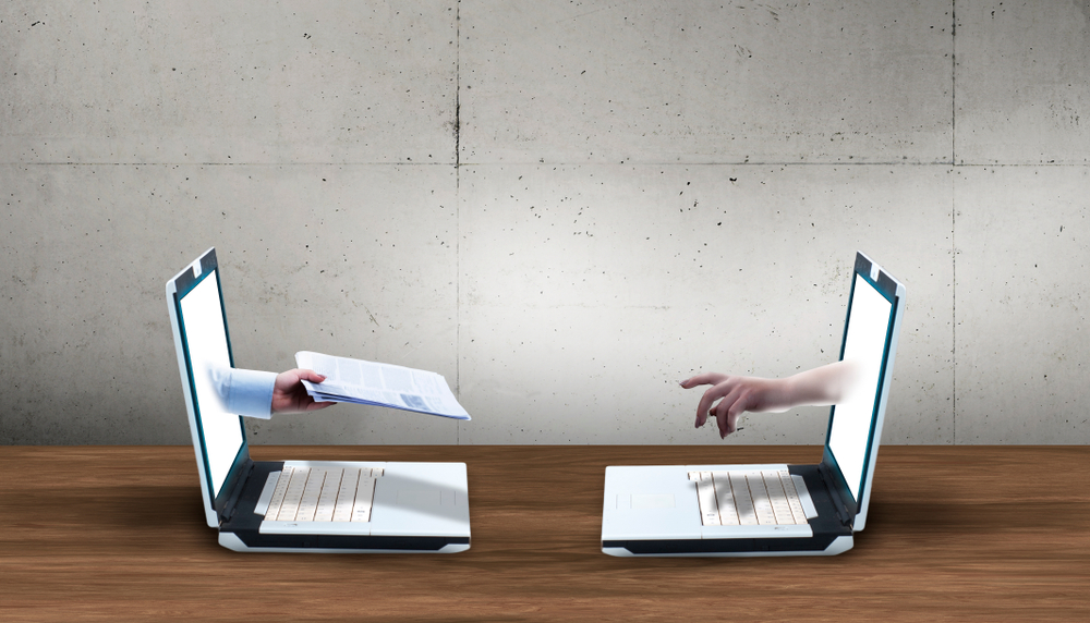 two laptops with each screen has hand and the other is giving resume