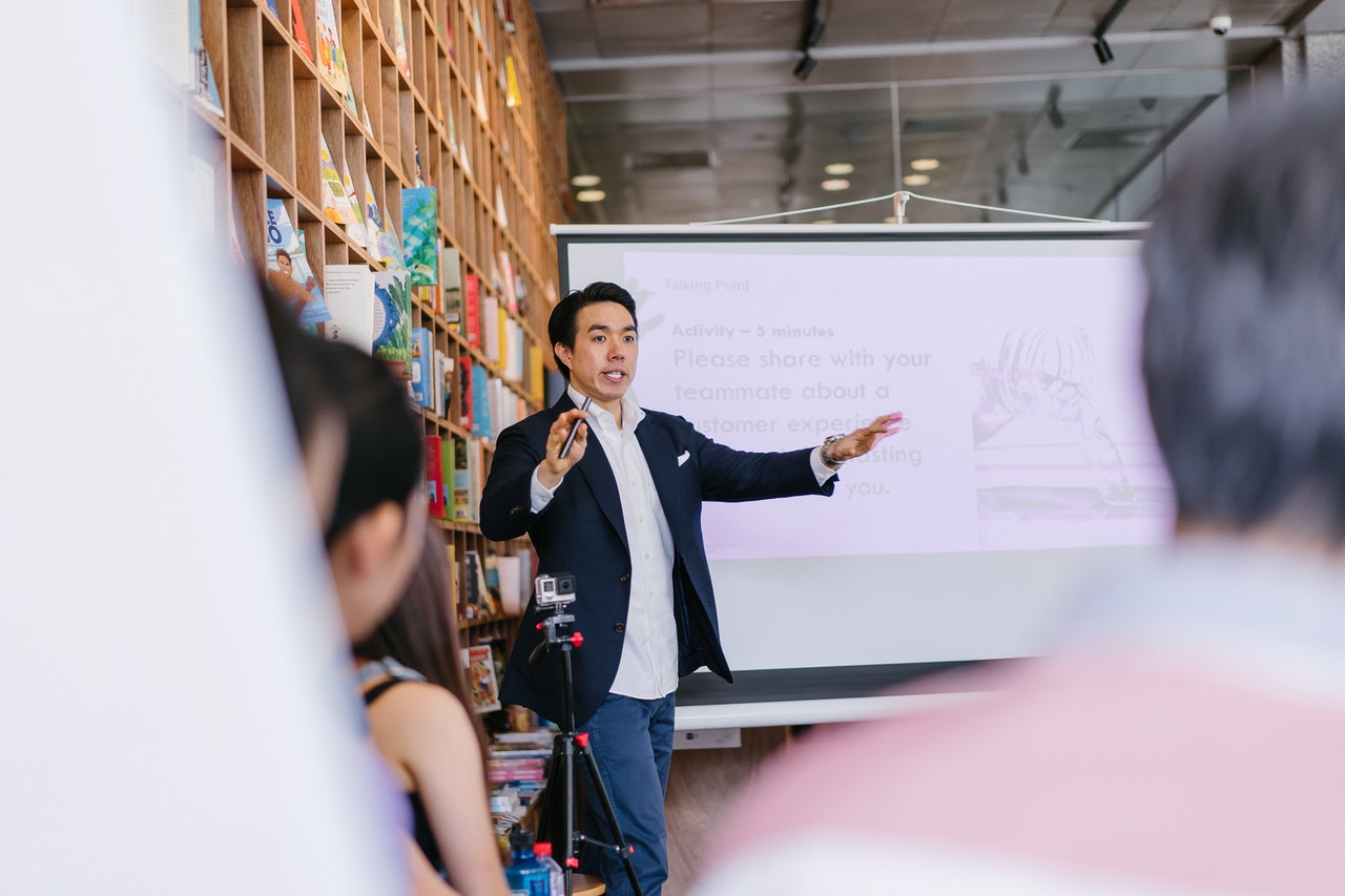 man in jacket teaching employees