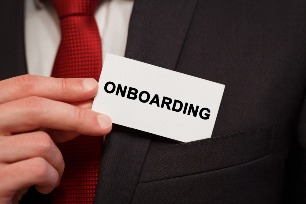 new hire holding an onboarding card