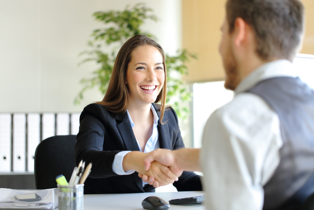 recruiter shaking hands with the female new hire