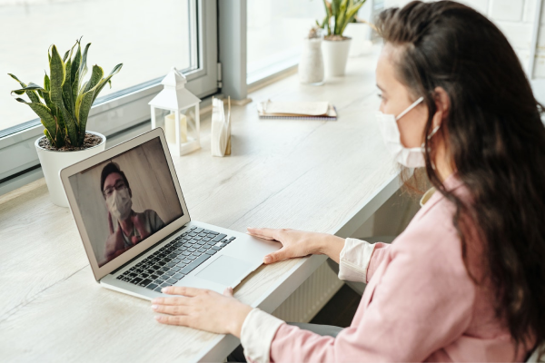 candidate having an online interview while wearing a face mask