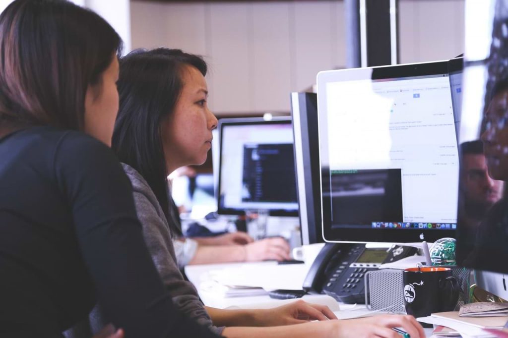 two women working on computer