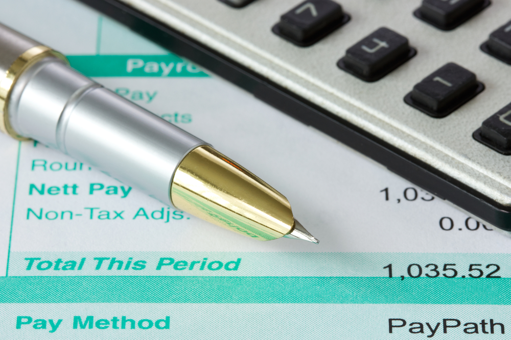 pen, calculator, and payroll summary details
