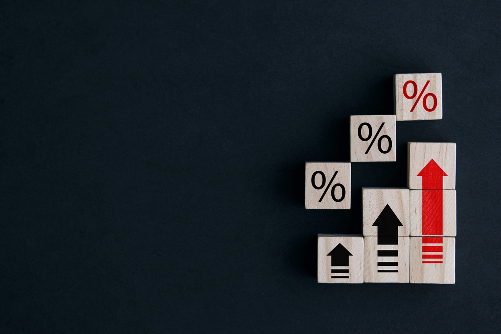 stacked wooden blocks with percentage signs and up arrow symbols