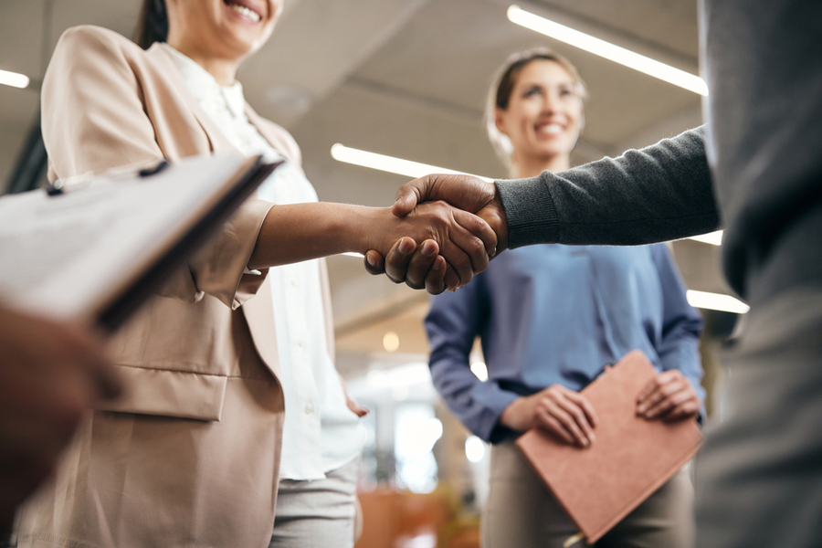 recruitment officer shaking hands with the new hire