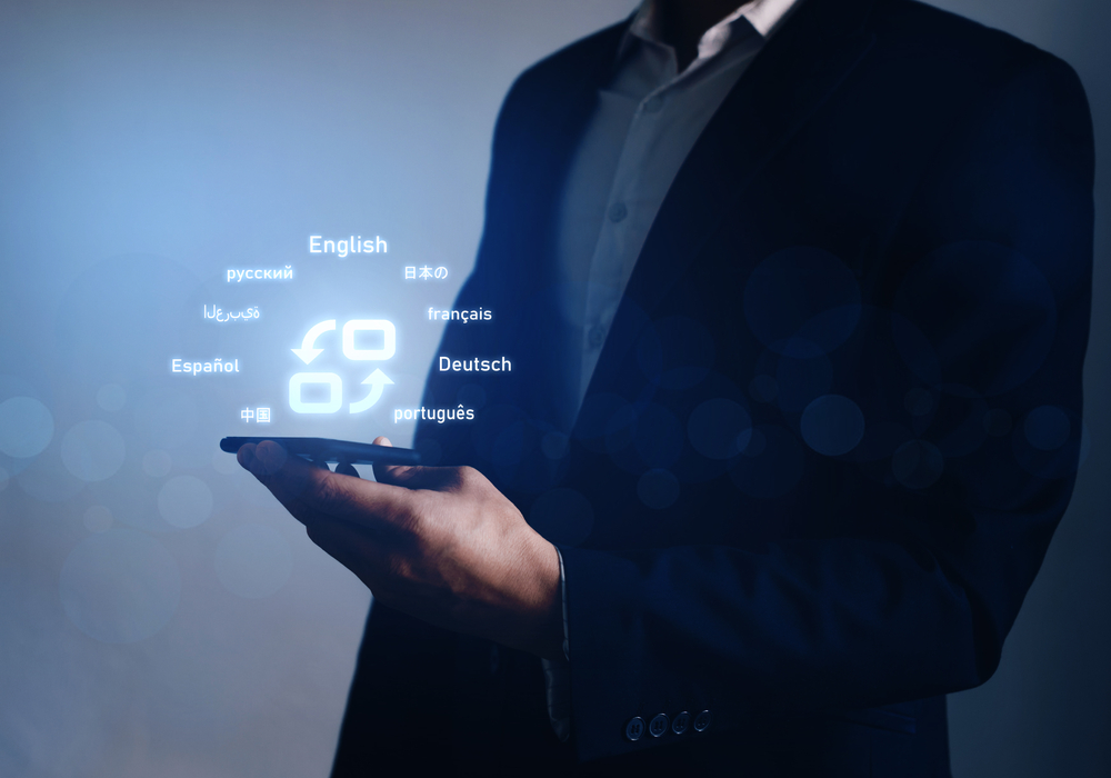 male job applicant holding a phone that shows choices of different languages