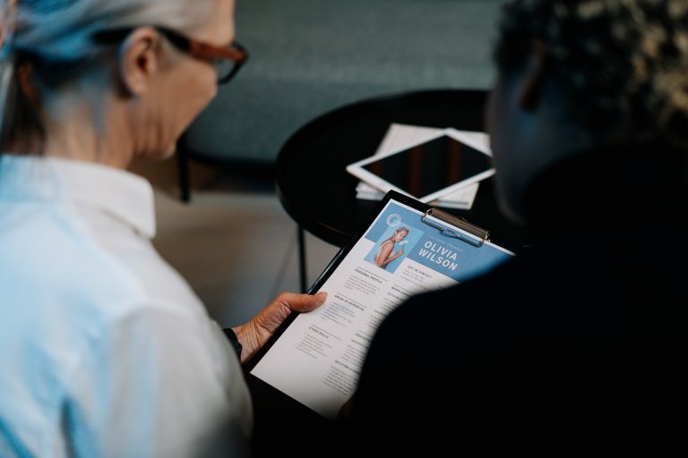 Two people checking a resume