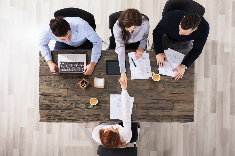 corporate recruiters shaking hand with candidate during interview