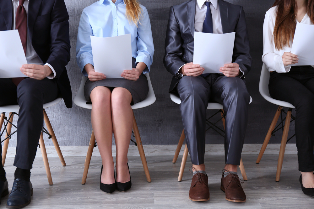 two male and two female job applicants sitting and waiting for an interview