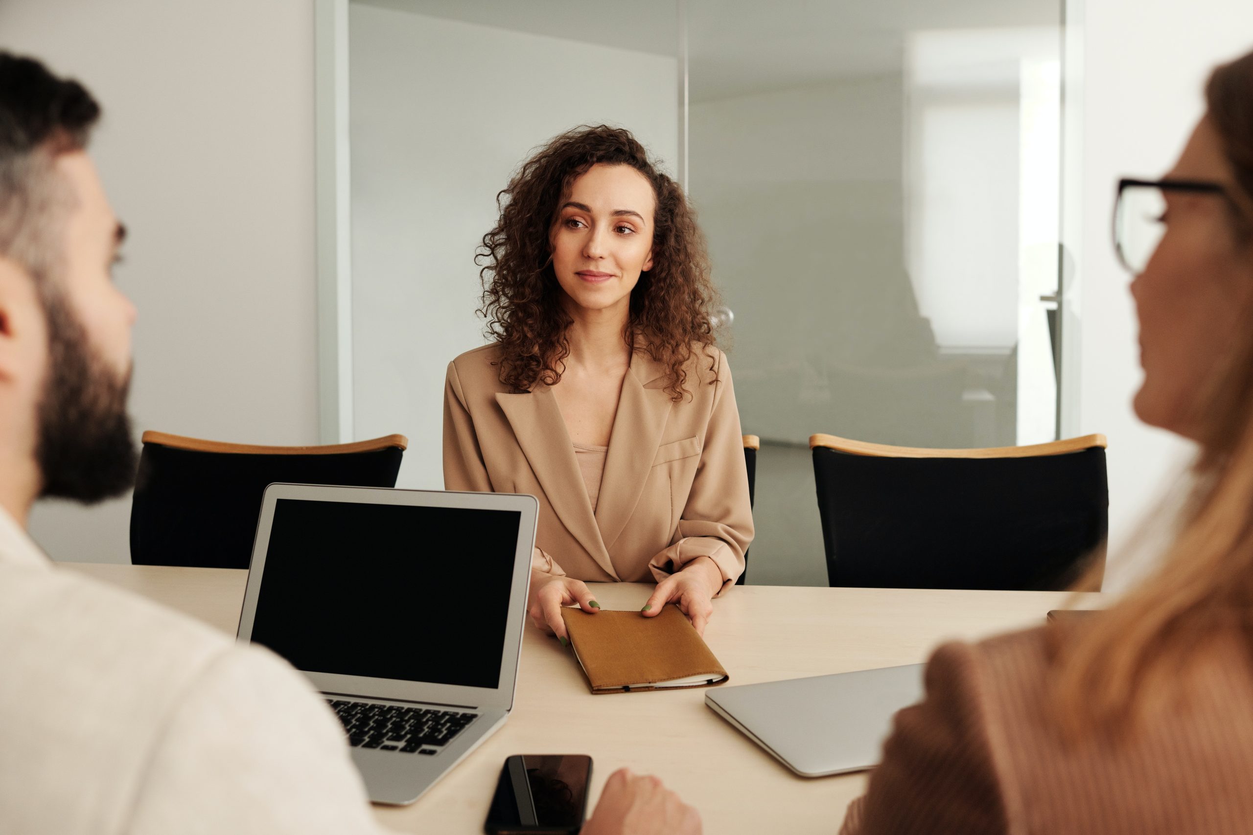 woman sitting in front of two recruiters during internal recruitment