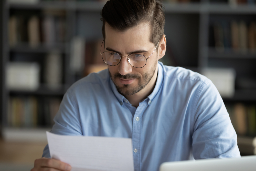 male recruiter sitting and reading a cover letter