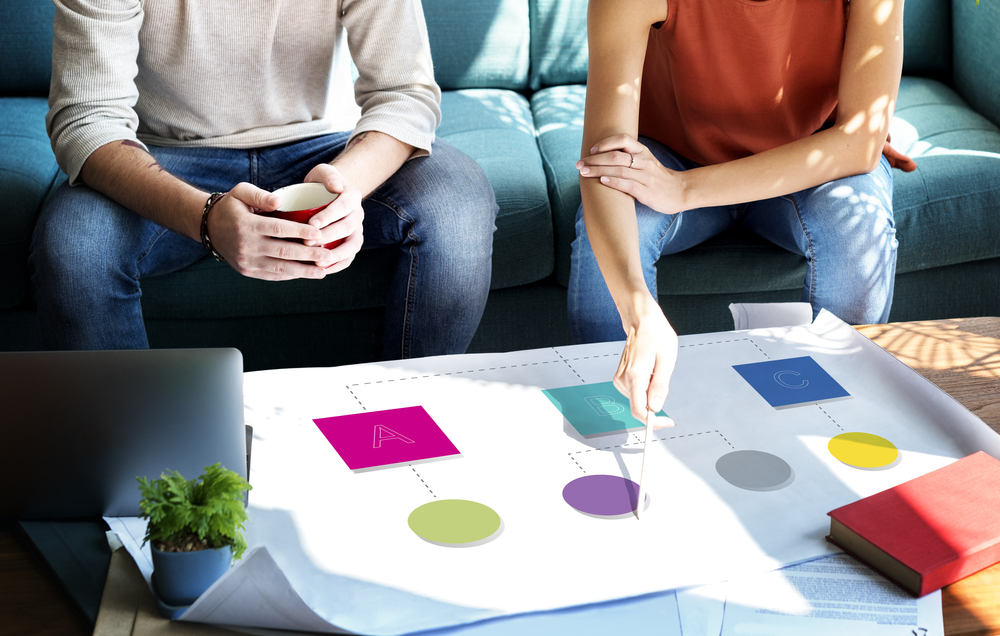 woman's hand pointing on a shape of a structure on whiteboard