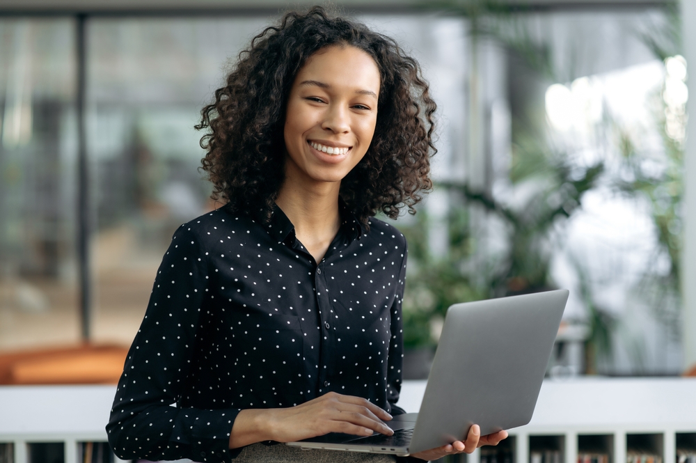 smiling female recruiter holding a laptop