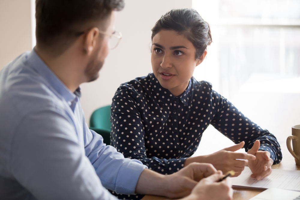 female and male employees talking in office