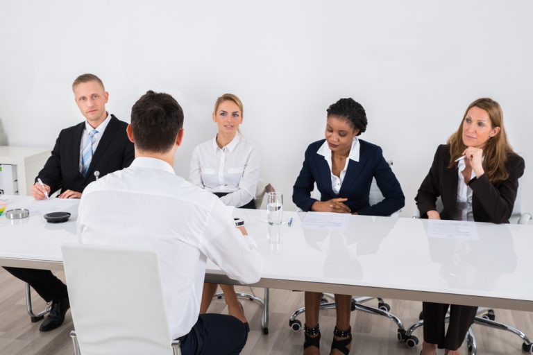 woman doing a panel interview with four recruiters