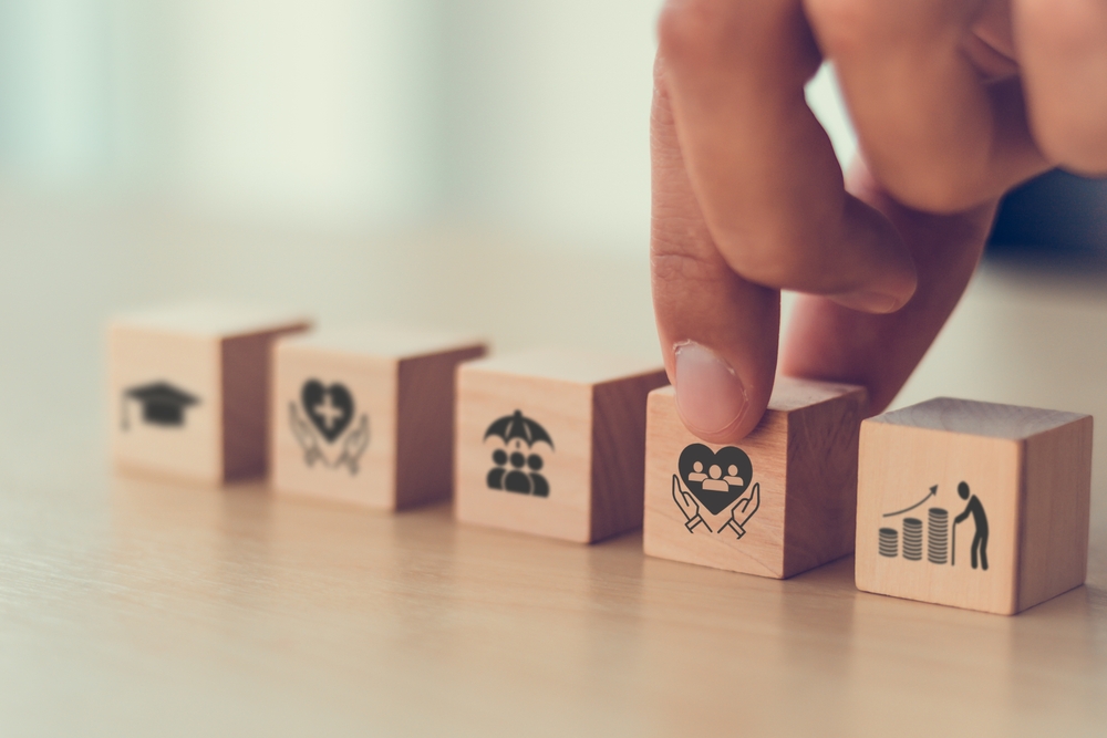 Employee benefits icons on wooden blocks