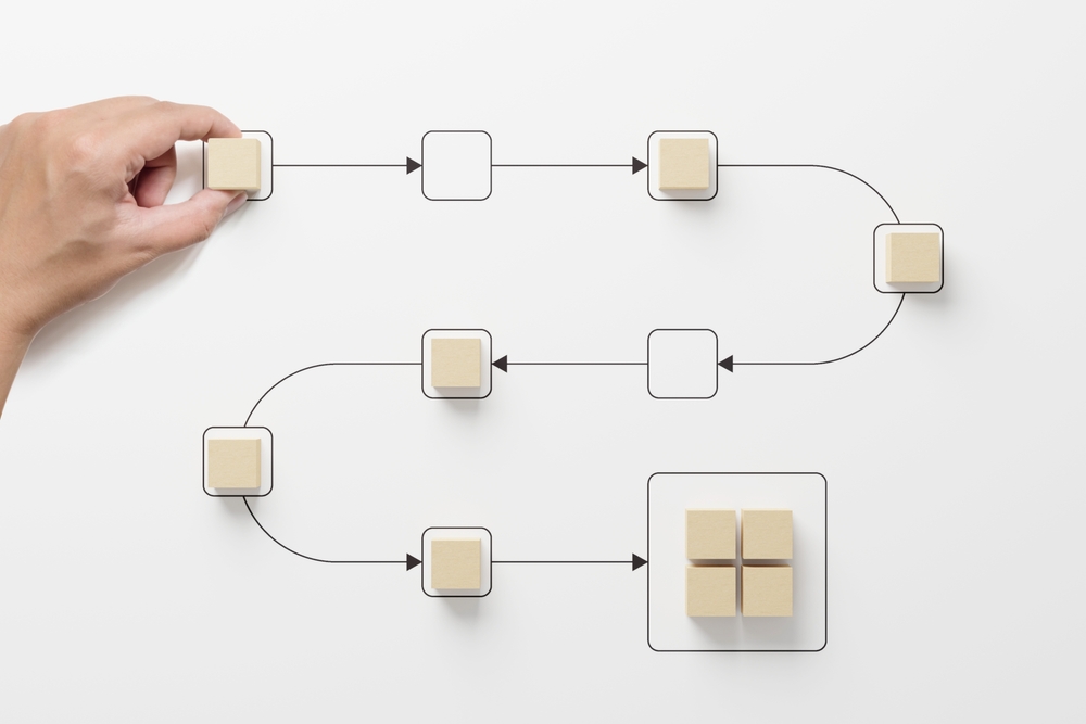 Hand holding wooden cube block arranging process