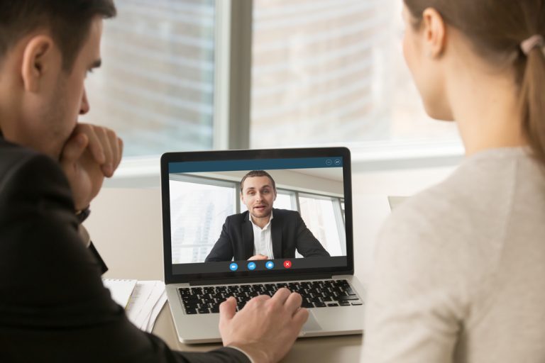 male and female recruiters remote interviewing a male candidate