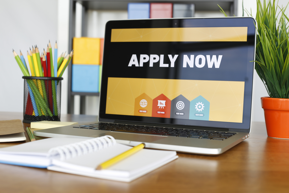 'apply now' displayed on a laptop